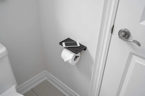 Oil Rubbed Bronze Wall Mount Toilet Paper Holder With Shelf And Phone Slot in bathroom installed next to the toilet