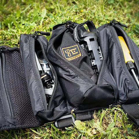 Open tool pack on grass showing contents for Handlebar Jack Portable Repair Stand V3 for E Bikes Bundle With Accessories