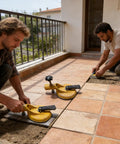 Two workers using a Floor Gap Fixer Tool For Tile And Stone Installations, Fast Leveling With A Strong Suction Cup on a patio.