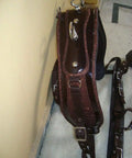 Nylon Horse Driving Harness With Patchwork Bridle hanging, showing durable double stitch construction and synthetic leather padding.