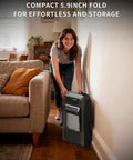 Person storing 18000 BTU Propane Heater For Indoor And Outdoor Use, 3 Adjustable Heat Settings, Portable Space Heater near a couch