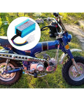 AC 5 Pin CDI Box For GY6 50cc To 160cc Engines with blue aluminum shell next to parked dirt bike on grass