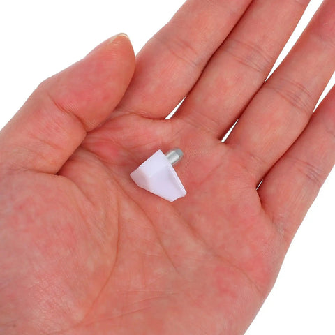 Hand holding a single piece of Heavy Duty Shelf Pins And Pegs Kit Plastic And Stainless Steel 200 Pieces White Stable Load Bearing Easy Installation