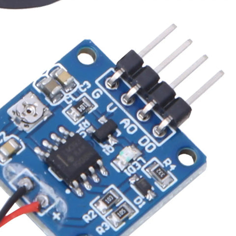 Close-up of a Piezoelectric Vibration Sensor Module with Adjustable Sensitivity and 5V DC Analog Output for Tapping Detection.
