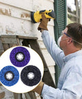 A person using a Six Pack Four And A Half Inch By Seven Eighths Inch Strip Discs Stripping Wheel For Angle Grinder Remove Paint Coating Rust Welds Oxidation Clean Up Jobs on wood siding, with three disc colors shown inset.