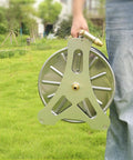 Heavy Duty Stainless Steel Garden Hose Reel With Smooth Rollup Crank held in hand, perfect for organizing hoses in yard.