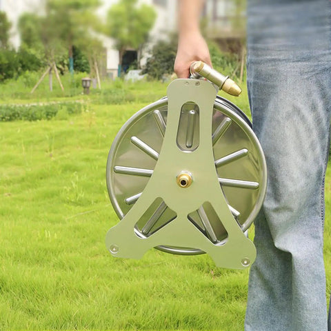 Heavy Duty Stainless Steel Garden Hose Reel With Smooth Rollup Crank held in hand, perfect for organizing hoses in yard.