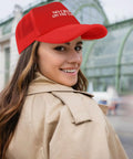 Woman wearing red womens breathable golf hat with six vent eyelets low profile unstructured cap moisture wicking sweatband.