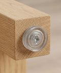 Close-up of 0.7 inch round screw-in leveling leg on wood, part of 40 Pcs Adjustable Furniture Feet With Threaded Design For Cabinets And Chairs