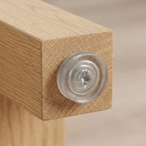 Close-up of 0.7 inch round screw-in leveling leg on wood, part of 40 Pcs Adjustable Furniture Feet With Threaded Design For Cabinets And Chairs