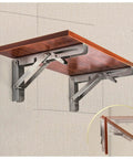 Heavy Duty Folding Shelf Brackets For Wall Mounted Console Tables holding a wooden top, rust resistant stainless steel support.