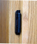 Cabinet door hinge, black iron, mounted on wood cabinet door (side view)