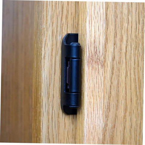 Cabinet door hinge, black iron, mounted on wood cabinet door (side view)
