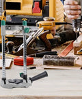 Adjustable Electric Drill Stand With 45 Degree Angle Drill Guide Holder in a woodworking shop with tools on a table