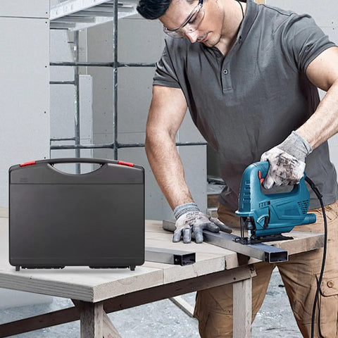 Man using jigsaw on plywood with black carrying case nearby