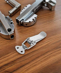 Stainless Steel Spring Toggle Lock Latches For Tool Box And Cabinet Doors With Smooth Action on a wooden surface.
