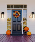 Slick Matte Black Outdoor Wall Sconce With Clear Glass And Rock Solid Frame For Front Door, illuminated by porch entrance.