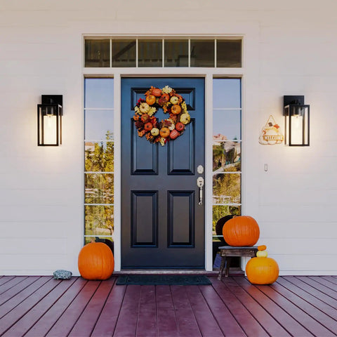 Slick Matte Black Outdoor Wall Sconce With Clear Glass And Rock Solid Frame For Front Door, illuminated by porch entrance.