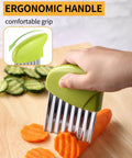 Crinkle cutter with green ergonomic handle; stainless steel blades slicing carrot on wooden board.
