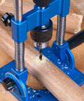 Close-up of Knockout Accuracy Portable Drill Guide And Angle Drill Jig For Perfectly Straight Holes Every Single Time, drilling into wood.