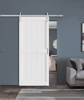40 x 84 Inch Solid Wood Paneled Sliding Barn Door With Brushed Nickel Hardware Kit, White Finish, installed in a modern living room