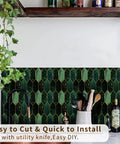 Holographic Emerald Art Deco Peel And Stick Backsplash Tiles in kitchen setting with utensils and plants.