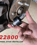 Wheel Stud Installer Tool Pro Grade Replacement for Cars SUVs Light Duty Trucks and RVs shown being used on wheel hub.