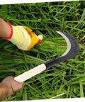 Close-up of Manganese Steel Long Handle Scythe For Weeding And Lawn Care Tough As Nails Heavy Duty Garden Tool cutting grass in garden