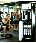 Slick Bottleless Water Dispenser Featuring Straight Up Four Stage Filtration And Game Changing Tankless Direct Connect Design in gym setting.
