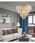Modern Round Metal And Glass Pendant Light With Six Leds overhead in a stylish living room setting, illuminating a cozy space.