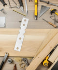 Heavy Duty Door Repair Plates 50 Pack For Iron And Wood Frames with tools on wooden surface