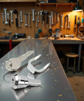Silver Universal Toolbox Lock With 180 Degree Rotation Unlocking, shown with keys and components on a metal workbench.