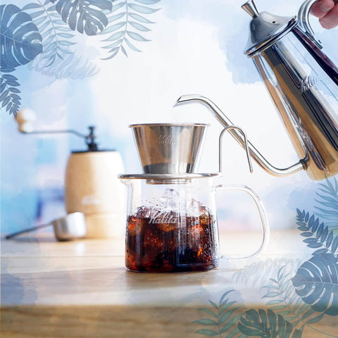 Close-up of Tsubame WDS185 Stainless Steel Coffee Dripper For 2 To 4 Folks With Wave Filter 185 in use, pouring into a glass carafe.