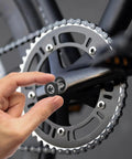 Hand installing 4 Pack Bike Hex Crank Arm Bolts 8mm M8 Thread High Strength Steel on a bicycle crankset.