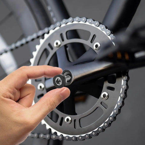 Hand installing 4 Pack Bike Hex Crank Arm Bolts 8mm M8 Thread High Strength Steel on a bicycle crankset.