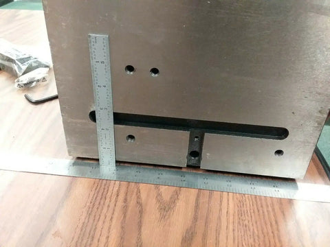 Precision Tilting Rotary Table With Six Jaw Self Centering Chuck For Dead Nuts Angular Control And Clean Sweeps On Cnc Or Manual Mill Rigs Gear Drives Zero To Ninety Degrees, showing detailed slotted base and measuring ruler.