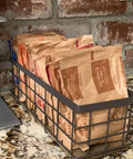 Farmhouse Small Metal Wire Storage Basket With Wooden Bottom Black Rustic Organizer holding packets on kitchen counter