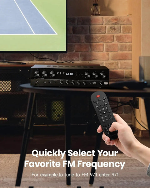 Image of Six Channel Home Theater Receiver With 1000W Peak Power, Bluetooth 5.3. A hand holds a remote in a living room setting.