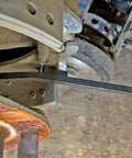 Brake Spring Bar For Heavy-Duty Tractor And Trailer S-Cam Brakes No-Wrench Tool With Molded Handle Black And Red in use