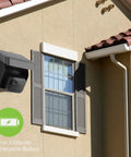 Solar Panel Charging Mount For Blink Outdoor 4th Gen And XT3 XT2 Cameras IP67 Weatherproof installed on house wall near window.