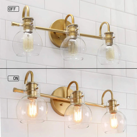 Gold 3 Light Vanity Light Fixture Over Mirror with Globe Clear Glass Shades for Bathroom Bedroom Kitchen Powder Room Sleek Chic Modern Minimalist Vanity Lighting, showing both on and off states against a tiled wall.