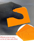 Gloved hand holding Six Pack Body Filler Spreaders Set 4 5 6 Inch Reusable Plastic Auto Body Spreader Tools For Applying Filler Putty Glaze
