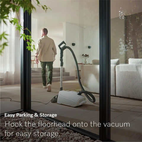 Premium Bagged Canister Vacuum For Hard Floors And Thin Carpet Featuring XL Parquet Brush Universal Floorhead Footswitch Hygienic Air Filter For Badass Suction And Slick Cleanup with floorhead hooked for storage.