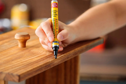 Hand using Wood Finish Stain Marker For Easy No Fuss Touch Ups Provincial Shade Nicks And Scratches On Wood Furniture And Crafts