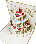 Akeydeco 3D pop-up birthday card with a white multi-tier cake, red candle, and red/blue floral accents.