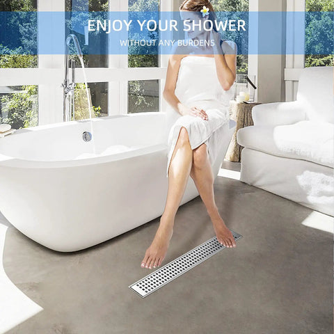 Woman sitting in bathroom with visible 36 Inch Linear Shower Drain In Brushed Nickel 304 Stainless Steel Floor Drain For Bathroom.