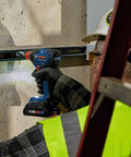 Worker using Two In One Cordless Impact Driver And Wrench 18V Connected Ready For One Fourth Inch And One Half Inch Bits And Sockets
