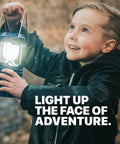 Child holding blue camping lantern, part of 4 Pack Multicolor Camping Lanterns, Ultra Bright LED Tent Lights for Power Outages.