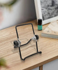 Two Pack Foldable Solar Panel Stands With Adjustable Tilt Mounts For Small And Large Panels on a wooden desk