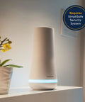SimpliSafe security base station with blue light indicator on table next to plant, requires SimpliSafe Security System text overlay.